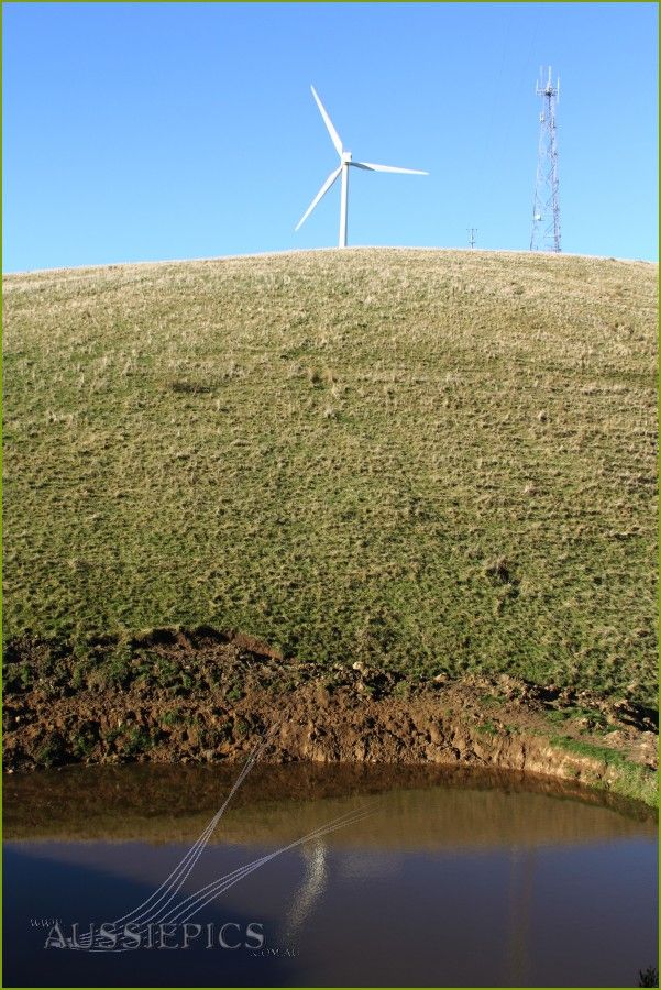 Windfarm shot, across a dam.